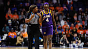 Jan 19, 2025; Gainesville, Florida, USA; LSU Tigers guard Flau'Jae Johnson (4) talks with NCAA referee Natasha Camy against the Florida Gators during the second half at Exactech Arena at the Stephen C. O'Connell Center. Mandatory Credit: Matt Pendleton-Imagn Images
