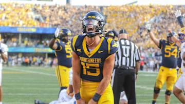 Sep 13, 2025; Morgantown, West Virginia, USA; West Virginia Mountaineers quarterback Scotty Fox Jr. (15) celebrates after a touchdown during the third quarter against the Pittsburgh Panthers at Milan Puskar Stadium. Mandatory Credit: Ben Queen-Imagn Images