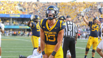Sep 13, 2025; Morgantown, West Virginia, USA; West Virginia Mountaineers quarterback Scotty Fox Jr. (15) celebrates after a touchdown during the third quarter against the Pittsburgh Panthers at Milan Puskar Stadium. Mandatory Credit: Ben Queen-Imagn Images