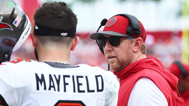 Sep 8, 2024; Tampa, Florida, USA;  Tampa Bay Buccaneers quarterback Baker Mayfield (6) talks with offensive coordinator Liam Coen against the Washington Commanders during the first half at Raymond James Stadium. Mandatory Credit: Kim Klement Neitzel-Imagn Images