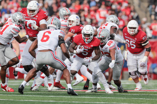 Defender prepares to tackle ball carrier.