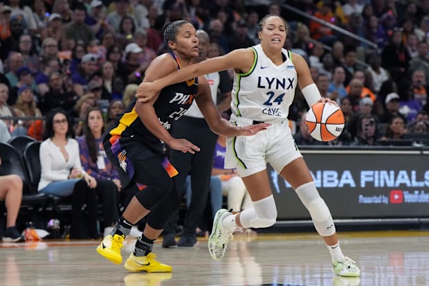 Minnesota Lynx forward Napheesa Collier (24) shields the ball from Phoenix Mercury forward Alyssa Thomas
