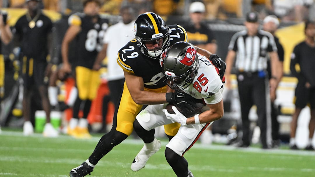 Aug 16, 2025; Pittsburgh, Pennsylvania, USA; Pittsburgh Steelers safety Sebastian Castro (29) tackles Tampa Bay Buccaneers wide receiver Garrett Greene (85) during the second half at Acrisure Stadium. Mandatory Credit: Barry Reeger-Imagn Images