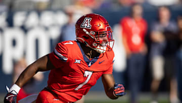 Nov 30, 2024; Tucson, Arizona, USA; Arizona Wildcats running back Quali Conley (7) against the Arizona State Sun Devils during the Territorial Cup at Arizona Stadium. Mandatory Credit: Mark J. Rebilas-Imagn Images