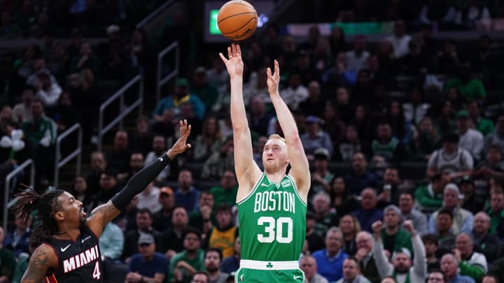 Apr 24, 2024; Boston, Massachusetts, USA; Boston Celtics forward Sam Hauser (30) shoots for three points against Miami Heat guard Delon Wright (4) in the second quarter during game two of the first round for the 2024 NBA playoffs at TD Garden. Mandatory Credit: David Butler II-USA TODAY Sports