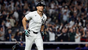 Oct 30, 2024; New York, New York, USA; New York Yankees designated hitter Giancarlo Stanton (27) reacts after hitting a home run during the third inning against the Los Angeles Dodgers in game five of the 2024 MLB World Series at Yankee Stadium. Mandatory Credit: Vincent Carchietta-Imagn Images