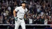Oct 30, 2024; New York, New York, USA; New York Yankees designated hitter Giancarlo Stanton (27) reacts after hitting a home run during the third inning against the Los Angeles Dodgers in game five of the 2024 MLB World Series at Yankee Stadium. Mandatory Credit: Vincent Carchietta-Imagn Images