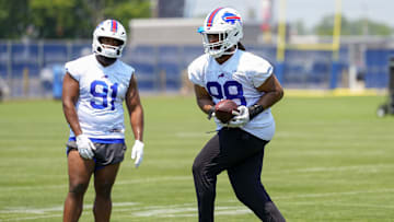 Jun 11, 2025; Orchard Park, NY, USA; Buffalo Bills defensive tackle T.J. Sanders (98) makes a catch with defensive tackle Ed Oliver (91) looking on during Minicamp at Highmark Stadium. Mandatory Credit: Gregory Fisher-Imagn Images