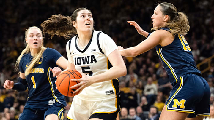 Iowa center Ava Heiden (5) turns toward the basket as Michigan forward Ashley Sofilkanich (15) and Michigan guard Olivia Olson (1) defend Feb. 22, 2026 at Carver-Hawkeye Arena in Iowa City, Iowa.