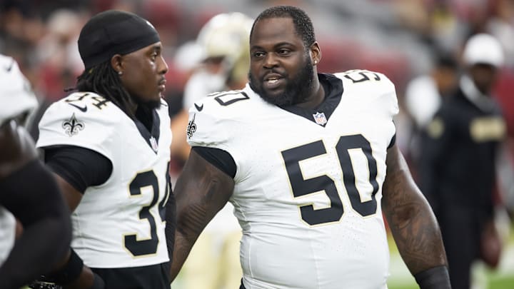 Aug 10, 2024; Glendale, Arizona, USA; New Orleans Saints  defensive tackle Khalen Saunders (50) with cornerback Kool-Aid McKinstry (34) against the Arizona Cardinals during a preseason NFL game at State Farm Stadium. Mandatory Credit: Mark J. Rebilas-Imagn Images