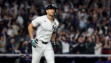 Oct 30, 2024; New York, New York, USA; New York Yankees designated hitter Giancarlo Stanton (27) reacts after hitting a home run during the third inning against the Los Angeles Dodgers in game five of the 2024 MLB World Series at Yankee Stadium. Mandatory Credit: Vincent Carchietta-Imagn Images