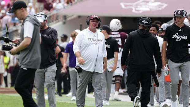 Texas A&M coach Mike Elko paces the sideline during a game against Utah State.