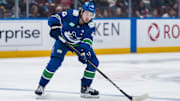 Apr 12, 2025; Vancouver, British Columbia, CAN; Vancouver Canucks defenseman Quinn Hughes (43) handles the puck against the Minnesota Wild in the second period at Rogers Arena. Mandatory Credit: Bob Frid-Imagn Images
