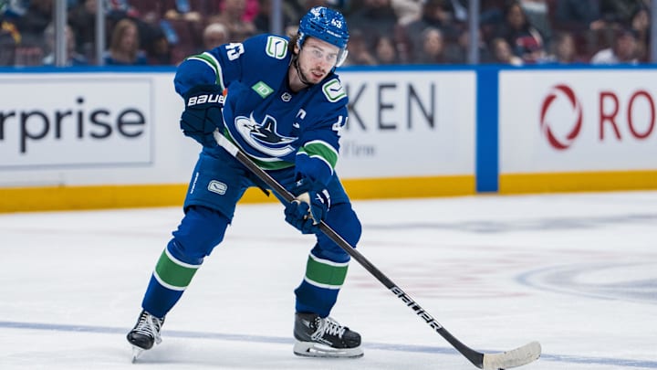 Apr 12, 2025; Vancouver, British Columbia, CAN; Vancouver Canucks defenseman Quinn Hughes (43) handles the puck against the Minnesota Wild in the second period at Rogers Arena. Mandatory Credit: Bob Frid-Imagn Images