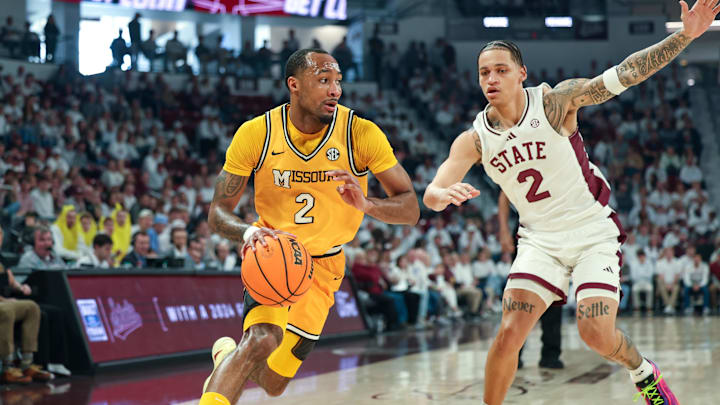Feb 1, 2025; Starkville, Mississippi, USA;  Missouri Tigers guard Tamar Bates (2) drives to the basket against Mississippi State Bulldogs guard Riley Kugel (2) during the first half at Humphrey Coliseum. Mandatory Credit: Wesley Hale-Imagn Images