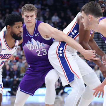 Dec 28, 2024; Salt Lake City, Utah, USA; Philadelphia 76ers forward Paul George (8) dribbles against Utah Jazz forward Lauri Markkanen (23) during the first quarter at Delta Center. Mandatory Credit: Rob Gray-Imagn Images