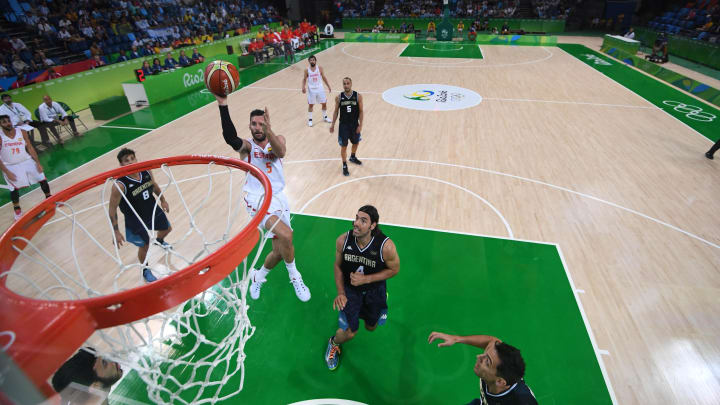 Aug 15, 2016; Rio de Janeiro, Brazil; Spain shooting guard Rudy Fernandez (5) shoots the ball in front of Argentina power forward Luis Scola (4) during the men's preliminary in the Rio 2016 Summer Olympic Games at Carioca Arena 1. 