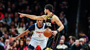 Jan 25, 2025; Phoenix, Arizona, USA; Phoenix Suns guard Devin Booker (1) points as Washington Wizards guard Bilal Coulibaly (0) watches the ball during the fourth quarter at Footprint Center. Mandatory Credit: Aryanna Frank-Imagn Images