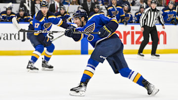 Dec 17, 2024; St. Louis, Missouri, USA;  St. Louis Blues center Jordan Kyrou (25) shoots against the New Jersey Devils during the second period at Enterprise Center. Mandatory Credit: Jeff Curry-Imagn Images