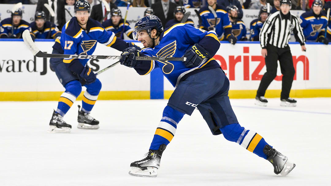 Dec 17, 2024; St. Louis, Missouri, USA;  St. Louis Blues center Jordan Kyrou (25) shoots against the New Jersey Devils during the second period at Enterprise Center. Mandatory Credit: Jeff Curry-Imagn Images