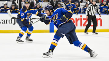 Dec 17, 2024; St. Louis, Missouri, USA;  St. Louis Blues center Jordan Kyrou (25) shoots against the New Jersey Devils during the second period at Enterprise Center. Mandatory Credit: Jeff Curry-Imagn Images