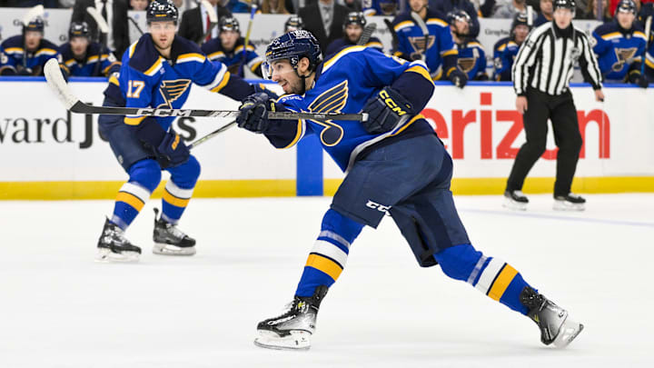 Dec 17, 2024; St. Louis, Missouri, USA;  St. Louis Blues center Jordan Kyrou (25) shoots against the New Jersey Devils during the second period at Enterprise Center. Mandatory Credit: Jeff Curry-Imagn Images