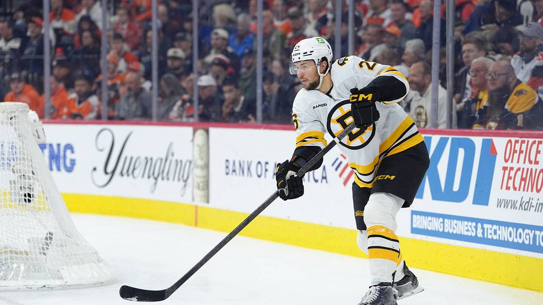Apr 5, 2026; Philadelphia, Pennsylvania, USA; Boston Bruins defenseman Andrew Peeke (26) passes the puck against the Philadelphia Flyers in the first period at Xfinity Mobile Arena. Mandatory Credit: Kyle Ross-Imagn Images