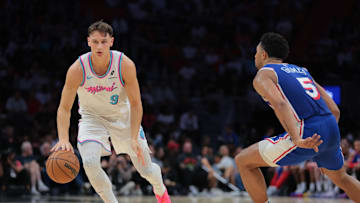 Apr 7, 2025; Miami, Florida, USA; Miami Heat guard Pelle Larsson (9) dribbles the basketball as Philadelphia 76ers guard Quentin Grimes (5) defends during the second quarter at Kaseya Center. Mandatory Credit: Sam Navarro-Imagn Images
