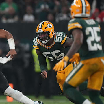 Sep 6, 2024; Sao Paulo, BRA; Philadelphia Eagles quarterback Jalen Hurts (1) runs from Green Bay Packers defensive end Kingsley Enagbare (55) during the second half at Neo Quimica Arena. Mandatory Credit: Kirby Lee-Imagn Images