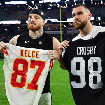 Jan 7, 2023; Paradise, Nevada, USA; Las Vegas Raiders defensive end Maxx Crosby (98) and Kansas City Chiefs tight end Travis Kelce (87) pose for photos after exchanging jerseys at Allegiant Stadium. Mandatory Credit: Gary A. Vasquez-USA TODAY Sports