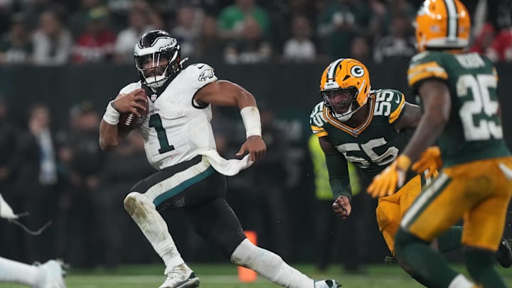 Sep 6, 2024; Sao Paulo, BRA; Philadelphia Eagles quarterback Jalen Hurts (1) runs from Green Bay Packers defensive end Kingsley Enagbare (55) during the second half at Neo Quimica Arena. Mandatory Credit: Kirby Lee-Imagn Images