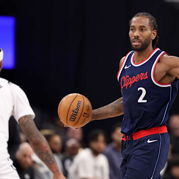 Jan 15, 2025; Inglewood, California, USA;  LA Clippers forward Kawhi Leonard (2) dribbles against Brooklyn Nets guard Keon Johnson (45) during the first half at Intuit Dome. Mandatory Credit: Kiyoshi Mio-Imagn Images