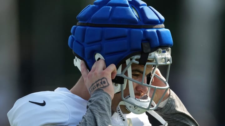 Indianapolis Colts defensive end Laiatu Latu (97) puts on his helmet as practice begins during training camp Tuesday, July 30, 2024, at Grand Park Sports Complex in Westfield.