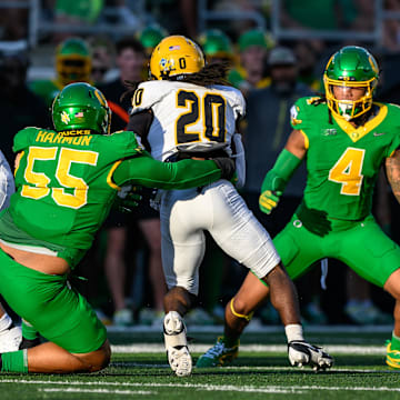 Aug 31, 2024; Eugene, Oregon, USA; Oregon Ducks defensive lineman Derrick Harmon (55) tackles Idaho Vandals running back Elisha Cummings (20) during the third quarter at Autzen Stadium. Mandatory Credit: Craig Strobeck-Imagn Images