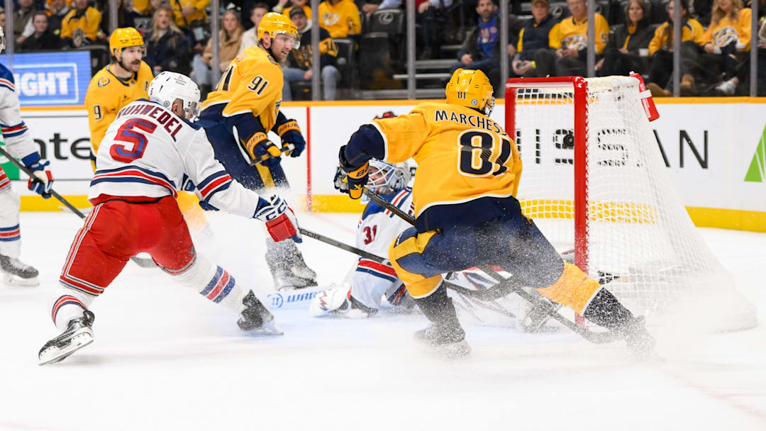 Dec 17, 2024; Nashville, Tennessee, USA;  Nashville Predators center Jonathan Marchessault (81) scores past New York Rangers goaltender Igor Shesterkin (31) during the first period at Bridgestone Arena. Mandatory Credit: Steve Roberts-Imagn Images