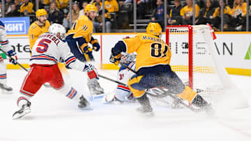 Dec 17, 2024; Nashville, Tennessee, USA;  Nashville Predators center Jonathan Marchessault (81) scores past New York Rangers goaltender Igor Shesterkin (31) during the first period at Bridgestone Arena. Mandatory Credit: Steve Roberts-Imagn Images