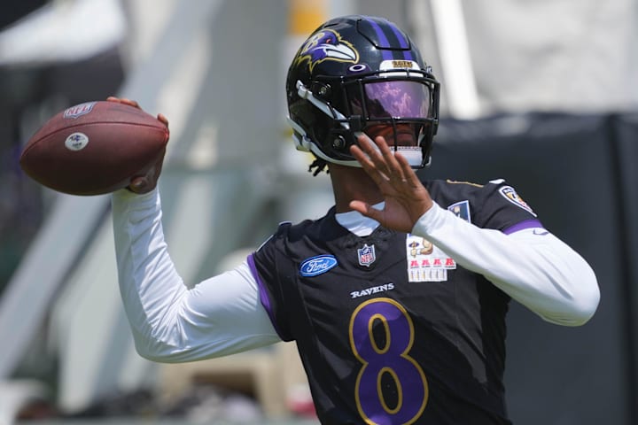 Baltimore Ravens quarterback Lamar Jackson warms up during training camp at Under Armour Performance Center.