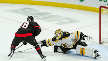 Jan 18, 2025; Ottawa, Ontario, CAN; Ottawa Senators center Tim Stutzle (18) moves the puck out of the reach of  Boston Bruins goalie Jeremy Swayman (1) to score in a shootout at the Canadian Tire Centre. Mandatory Credit: Marc DesRosiers-Imagn Images