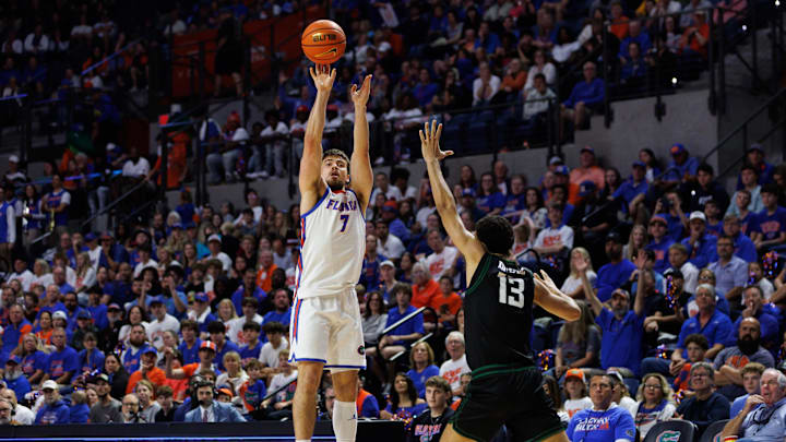 Dec 29, 2024; Gainesville, Florida, USA; Florida Gators guard Urban Klavzar (7) shoots a three point basket over Stetson Hatters forward Alex Doyle (13) during the second half at Exactech Arena at the Stephen C. O'Connell Center. Mandatory Credit: Matt Pendleton-Imagn Images