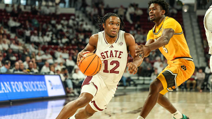Feb 1, 2025; Starkville, Mississippi, USA; Mississippi State Bulldogs guard Josh Hubbard (12) drives to the basket against Missouri Tigers guard Annor Boateng (6) during the second half at Humphrey Coliseum. Mandatory Credit: Wesley Hale-Imagn Images