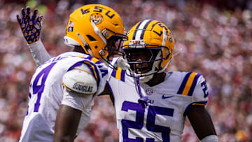Sep 14, 2024; Columbia, South Carolina, USA; LSU Tigers cornerback Javien Toviano (25) celebrates with cornerback Zy Alexander (14) after an interception against the South Carolina Gamecocks in the first quarter at Williams-Brice Stadium. Mandatory Credit: Scott Kinser-Imagn Images