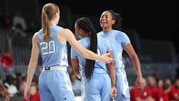 Nov 25, 2024; Paradise Island, Bahamas, BHS; North Carolina Tar Heels guard Indya Nivar (24) celebrates with North Carolina Tar Heels guard Reniya Kelly (10) and North Carolina Tar Heels guard Lexi Donarski (20) during the second half against the Indiana Hoosiers at the Atlantis Resort. Mandatory Credit: Kevin Jairaj-Imagn Images