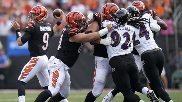 Sep 17, 2023; Cincinnati, Ohio, USA; Cincinnati Bengals center Ted Karras (64), Cincinnati Bengals guard Alex Cappa (65) and Cincinnati Bengals offensive tackle Orlando Brown Jr. (75) block as Cincinnati Bengals quarterback Joe Burrow (9) throws in the second quarter at Paycor Stadium. Mandatory Credit: Sam Greene-USA TODAY Sports