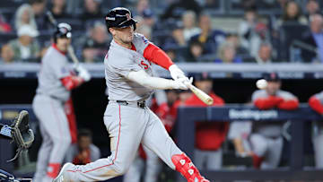 Oct 1, 2025; Bronx, New York, USA; Boston Red Sox third baseman Alex Bregman (2) hits a single during the eighth inning against the New York Yankees during game two of the Wildcard round for the 2025 MLB playoffs at Yankee Stadium. Mandatory Credit: Brad Penner-Imagn Images
