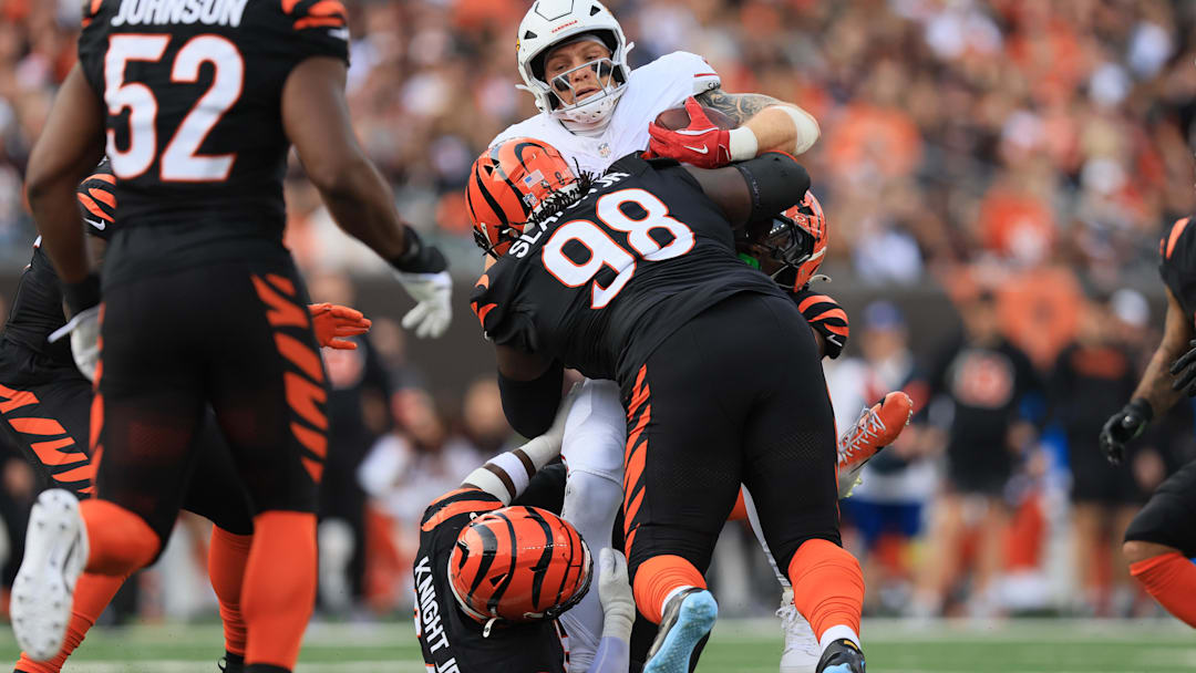 Dec 28, 2025; Cincinnati, Ohio, USA; Cincinnati Bengals defensive tackle T.J. Slaton Jr. (98) and linebacker Demetrius Knight Jr. (44) tackle Arizona Cardinals tight end Trey McBride (85) during the second half at Paycor Stadium. Mandatory Credit: Katie Stratman-Imagn Images Dec 28, 2025; Cincinnati, Ohio, USA; Cincinnati Bengals defensive tackle T.J. Slaton Jr. (98) and linebacker Demetrius Knight Jr. (44) tackle Arizona Cardinals tight end Trey McBride (85) during the second half at Paycor Stadium. Mandatory Credit: Katie Stratman-Imagn Images