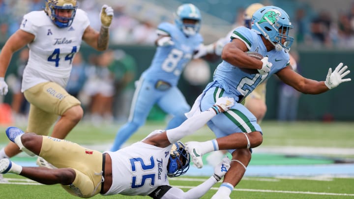 Nov 11, 2023; New Orleans, Louisiana, USA; Tulsa Golden Hurricane safety Jaise Oliver (25) tries to tackler Tulane Green Wave running back Makhi Hughes (21) in first quarter action at Yulman Stadium. 