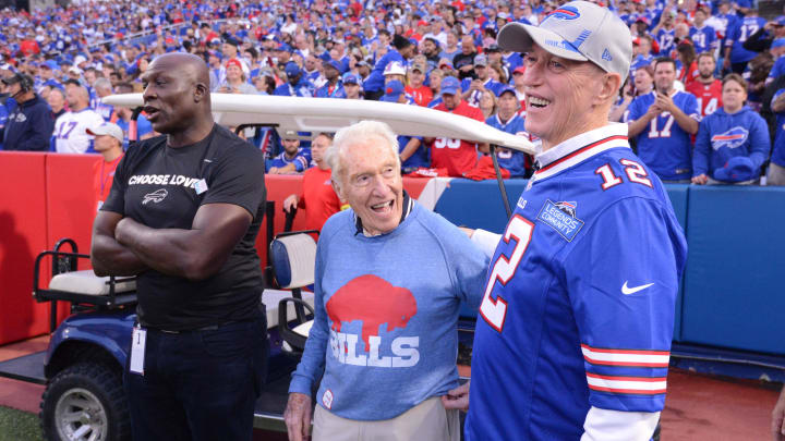 Sep 19, 2022; Orchard Park, New York, USA; Former Buffalo Bills head coach Marv Levy (center) is flanked by his former players Bruce Smith (left) and Jim Kelly before a game between the Buffalo Bills and the Tennessee Titans at Highmark Stadium. Mandatory Credit: Mark Konezny-USA TODAY Sports