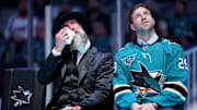 Nov 23, 2024; San Jose, California; San Jose Sharks former player Joe Thornton wipes away tears as he sits on the stage with former teammate Ryane Clowe at a ceremony honoring Thornton and retiring his number 19 jersey before a game between the San Jose Sharks and the Buffalo Sabres at SAP Center. Mandatory Credit: Ezra Shaw/Pool Photo via Imagn Images