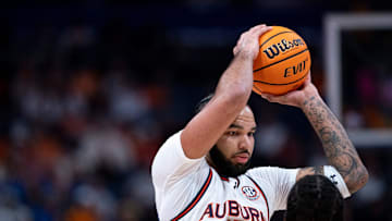 Auburn forward Johni Broome (4) pulls down a rebound against Tennessee forward Felix Okpara (34)during the first half of their semifinal game of the SEC Men's Basketball Tournament at Bridgestone Arena in Nashville, Tenn., Saturday, March 15, 2025.