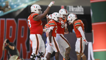 Oct 28, 2023; Miami Gardens, Florida, USA; Miami Hurricanes running back Ajay Allen (28) celebrates with teammates after scoring a touchdown against the Virginia Cavaliers during the third quarter at Hard Rock Stadium. Mandatory Credit: Sam Navarro-USA TODAY Sports